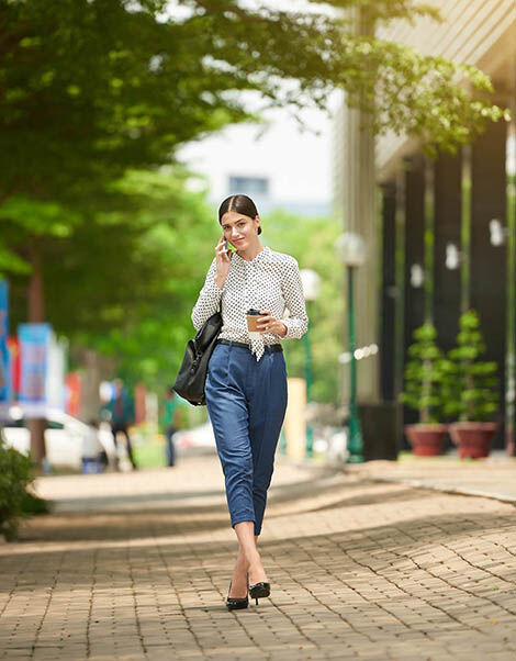 Business woman walking outside